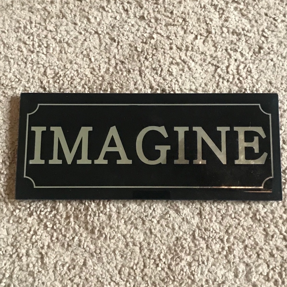 Black and silver “Imagine” sign